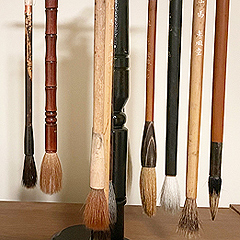 Diana Meng’s paintbrushes hang by their handles