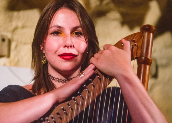 Joe Scott of Jude Brothers: a young woman embracing a harp, gazing into the camera