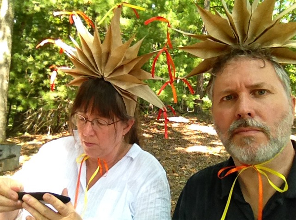 Sara Gowan and Bill Quern model many-pointed 'hats' made from paper bags and ribbons