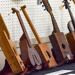 A row of cigar-box guitars