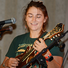 A woman tries out a ukulele