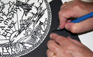 Master artist Susan Leviton works on a traditional Jewish papercut project.