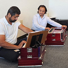 Muskan Balampaki teaches Bhagirath Khatiwada to play the harmonium