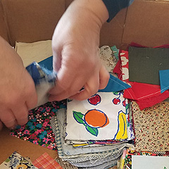 Sharon Zook handles precut fabric squares