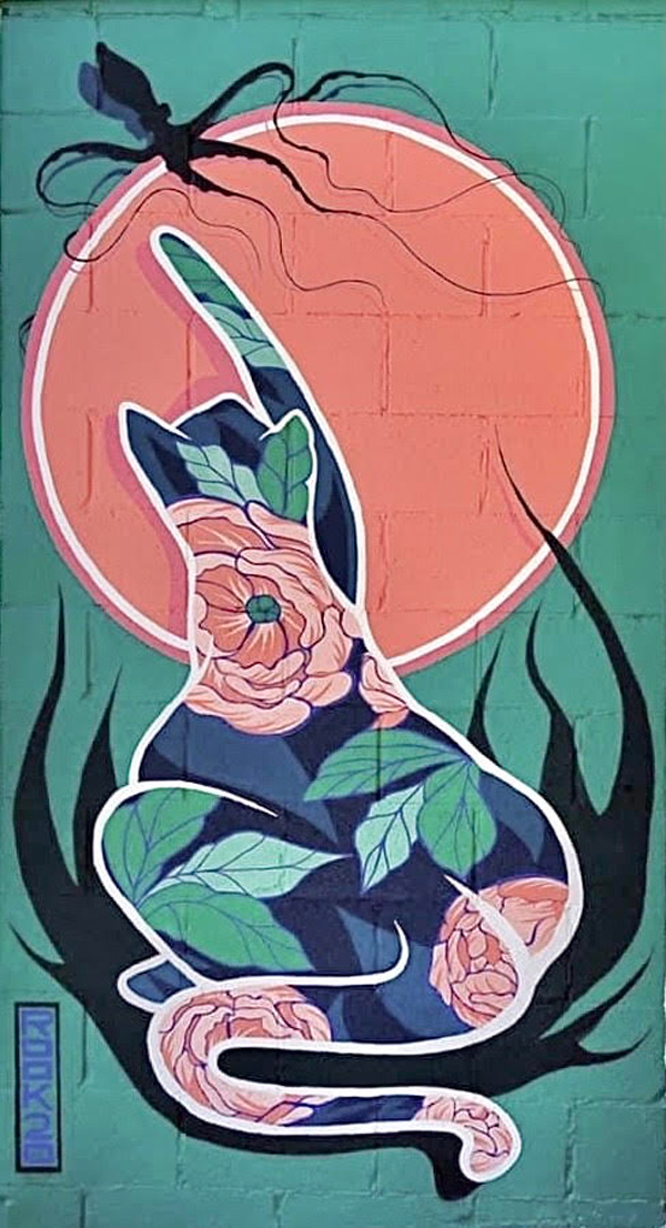 A stylized cat is silhouetted against a large orange disc, reaching up to bat at a small squid with very long trailing tentacles. The cat outline is filled with large peony flowers and leaves.