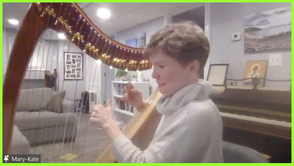 Mary-Kate Lee smiles as she plays her harp.