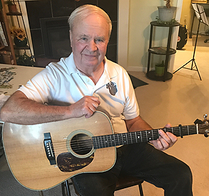Walt Crider at home with his guitar